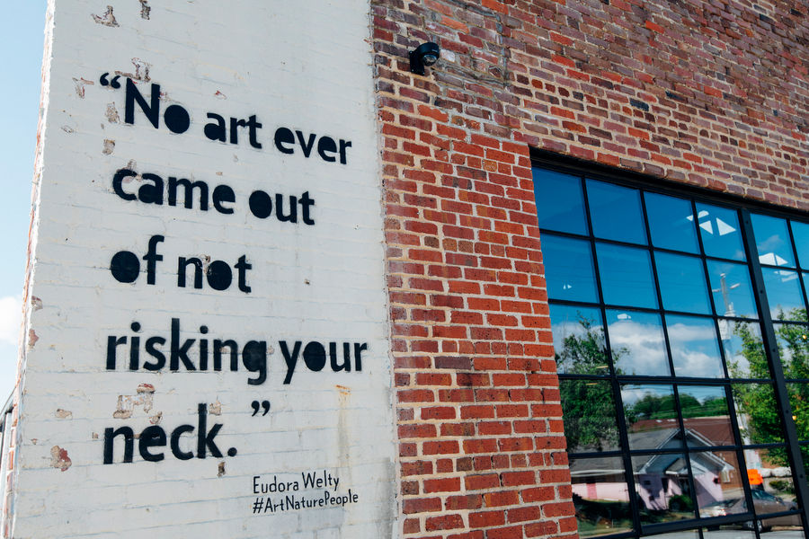 Quote reading "No art every came out of not risking your neck" by artist Eudora Wetly
