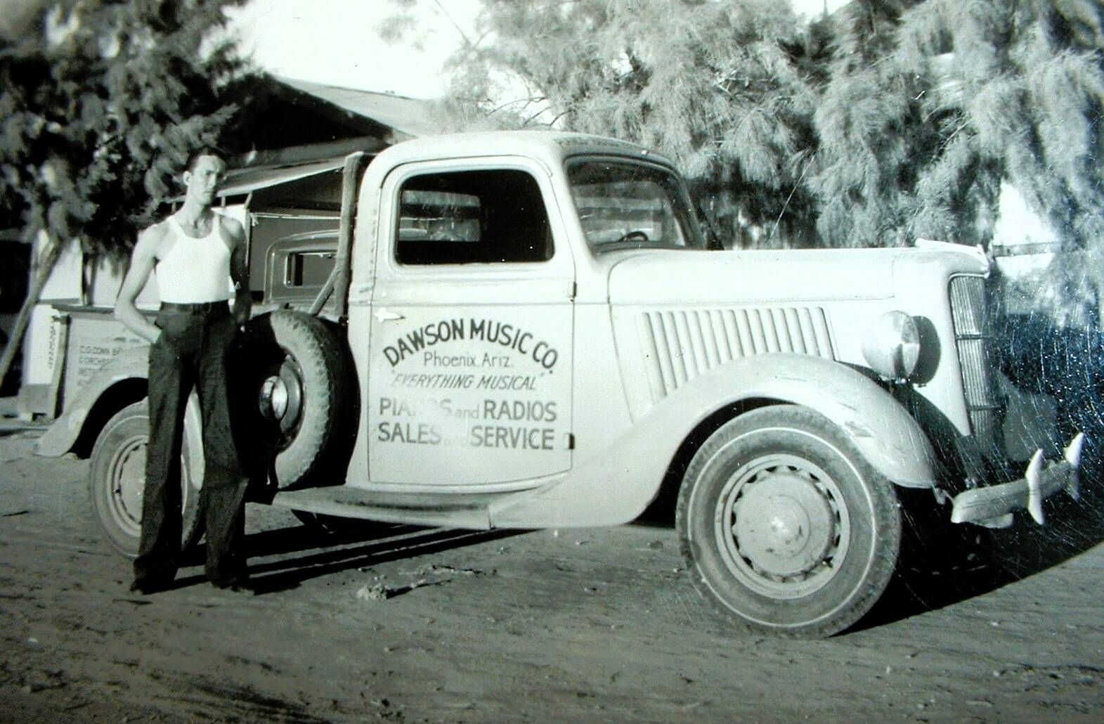 Charles “Buck” Harris next to the Dawson’s Music Truck, 1937.