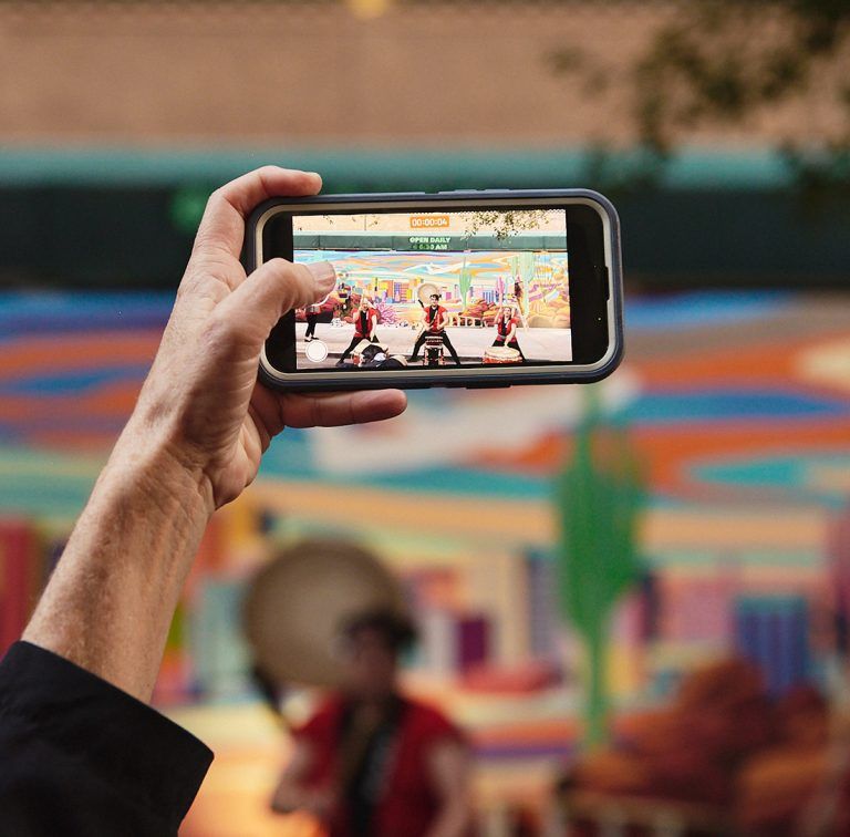 Hand Holding Phone at Event