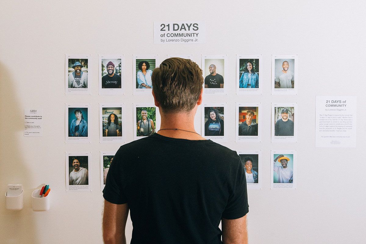 Back of head of person looking at photos on wall