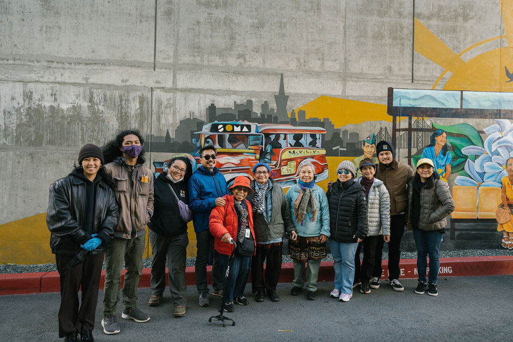 SOMA Pilipina Community members posing in front of the mural