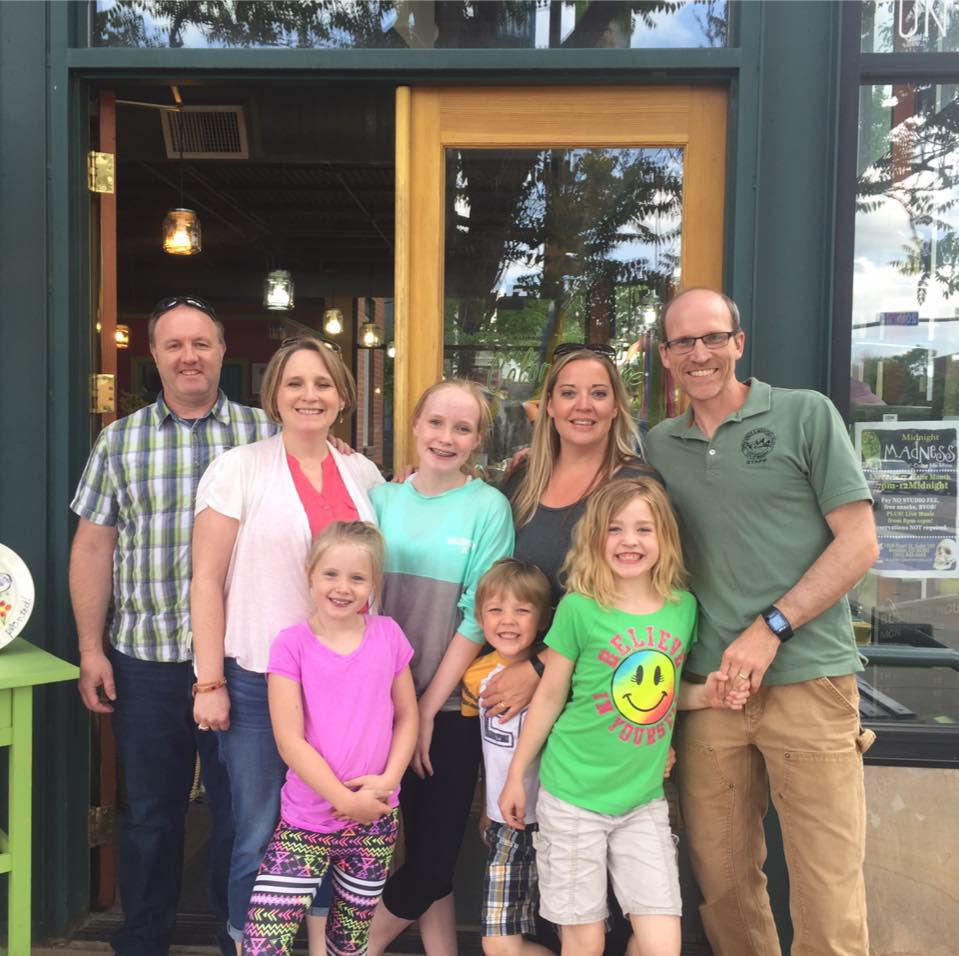 Lisa and Sandy with family outside store