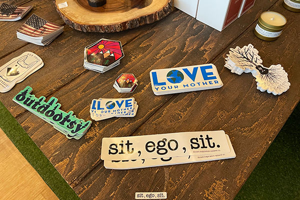 Several stacks stickers sit on a wooden table