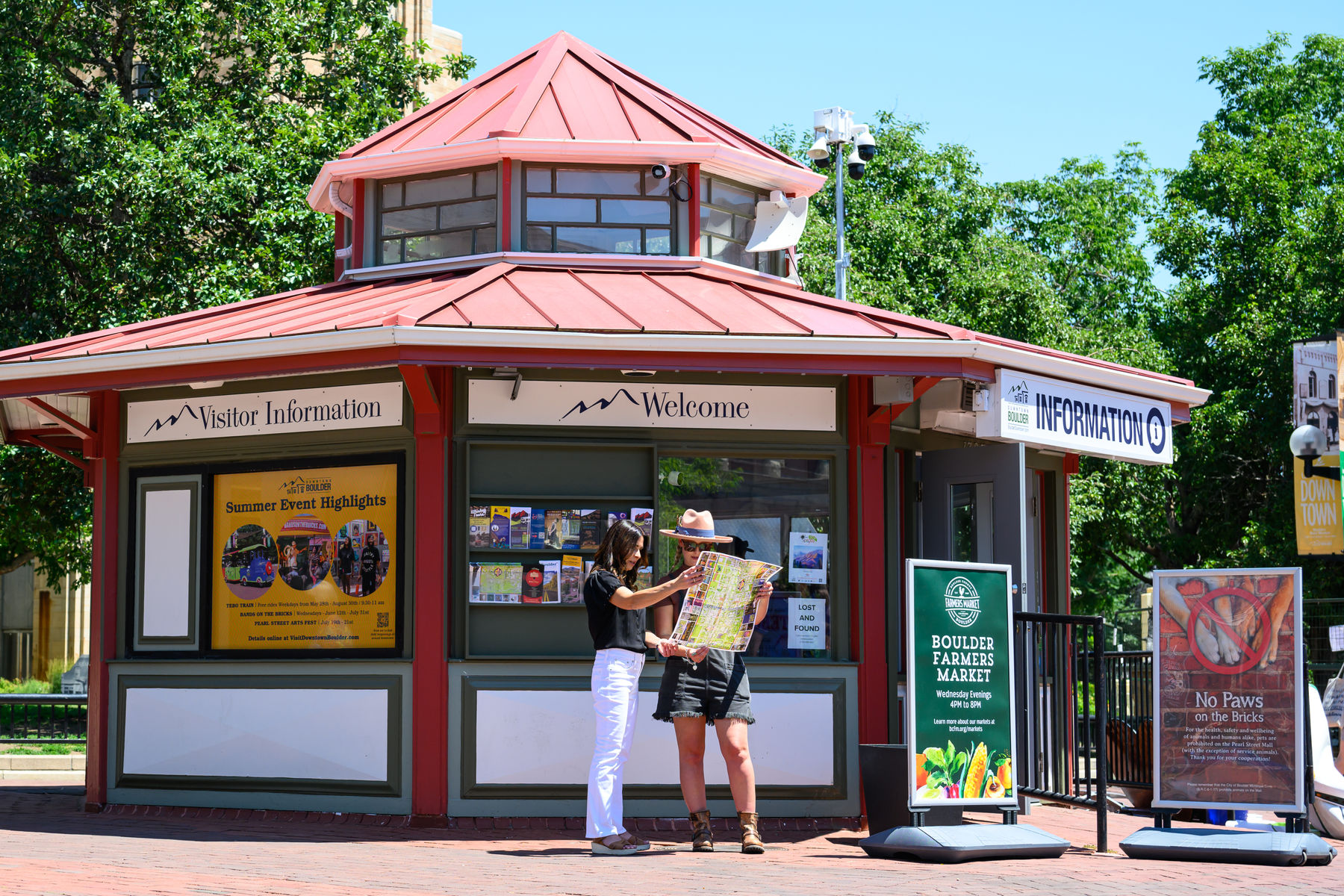 two women looking at the downtown Boulder guidebook at the Visitor Information Center