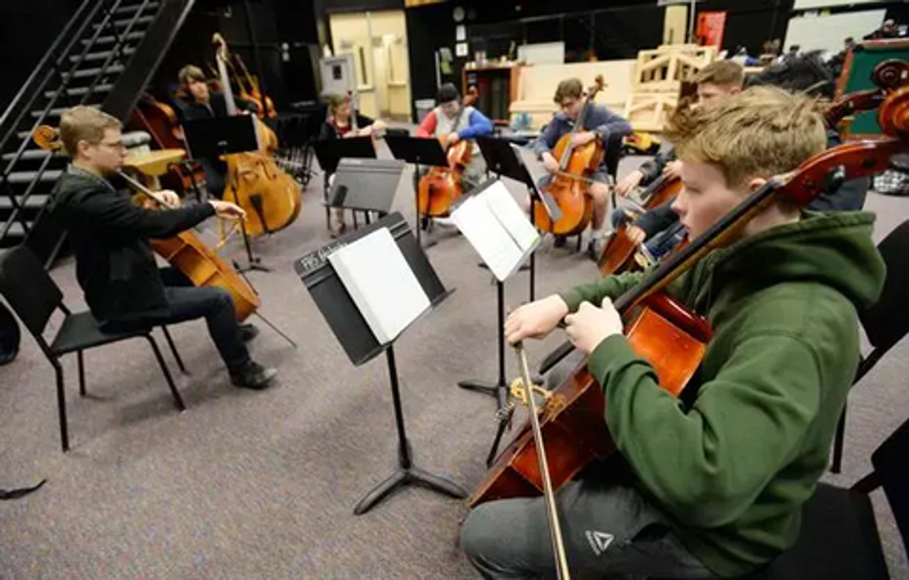 students playing cellos in orchestra class