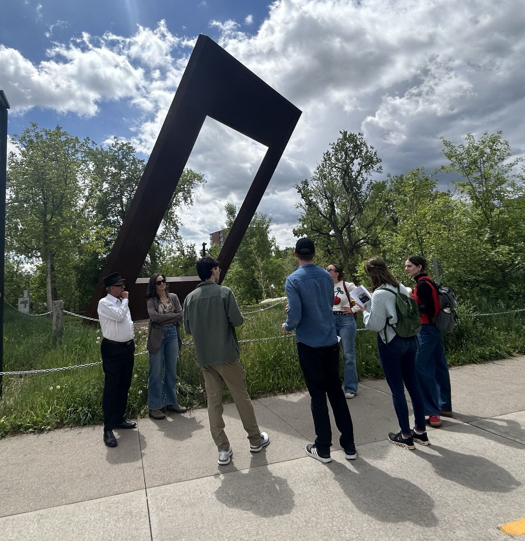 City of Boulder public walking tour attendees looking at sculpture