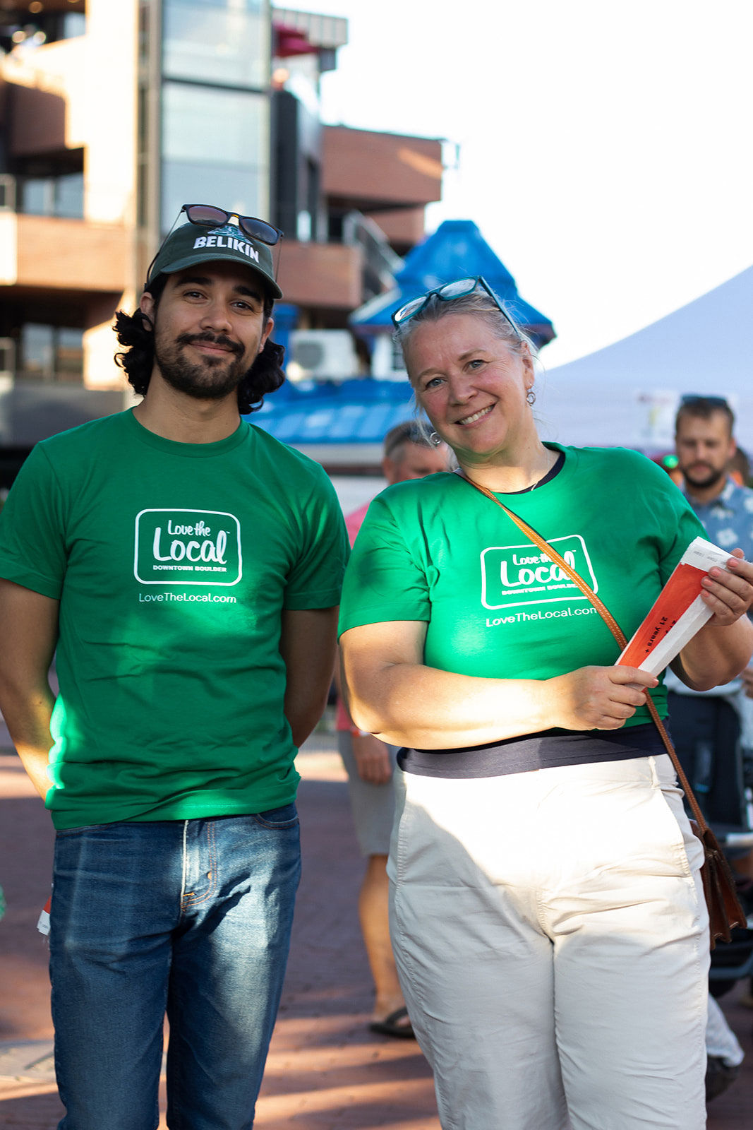 	A man and a woman in volunteer t-shirts