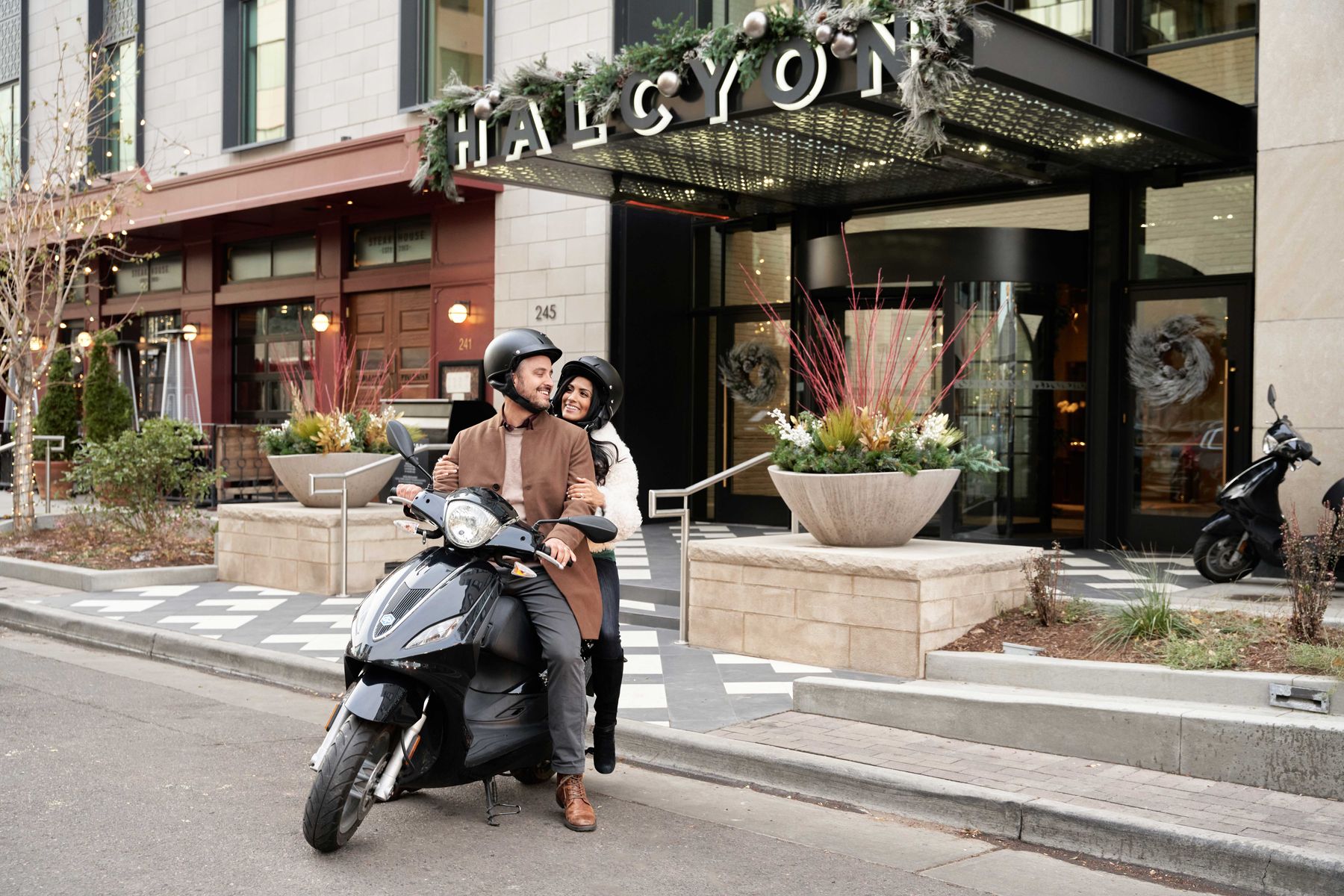 Couple on a scooter rental at Halcyon, a hotel in Cherry Creek