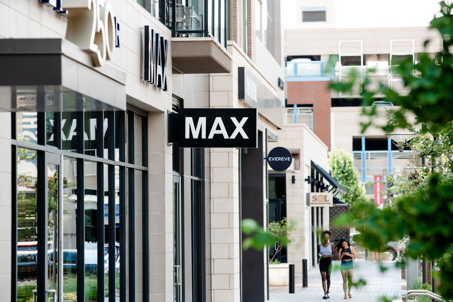 Two women walking down the street next to shops in Cherry Creek North.