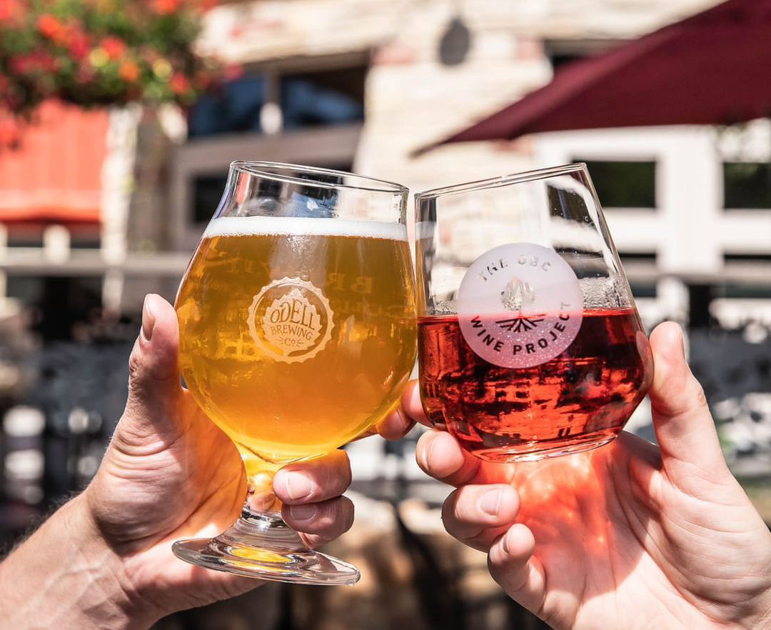 Glass of beer and wine on patio at Odell's