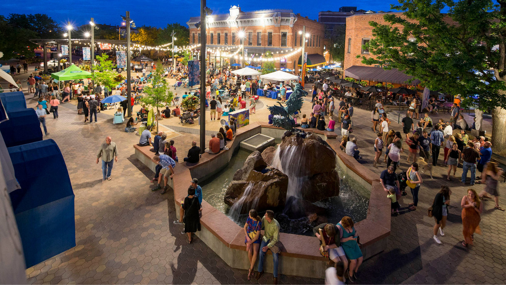 community enjoying an event at night under twinkling lights in Old Town Square