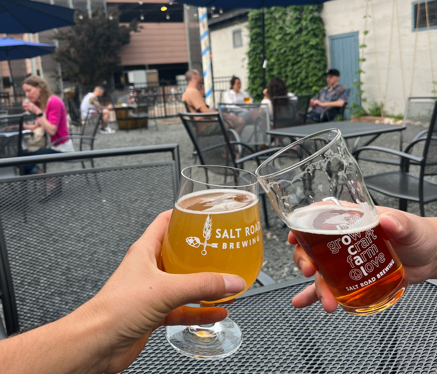 Two beers cheers on patio at Salt Road Brewing