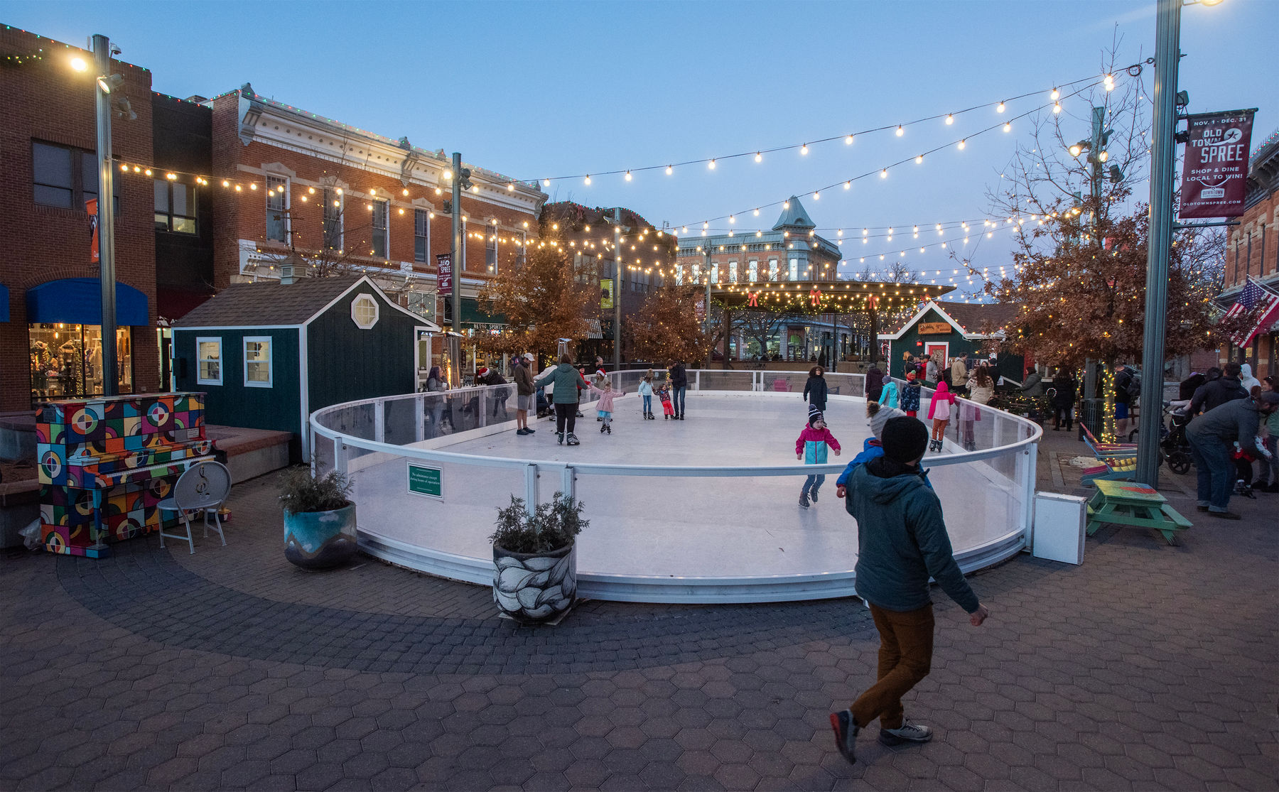 Families enjoying the Skate Rink surrounded by holiday decorations in Old Town Square