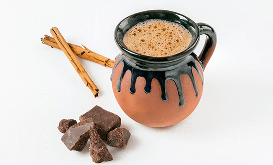 champurrado, a chocolate drink, served in a clay mug