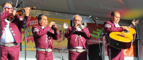 four mariachi musicians performing at a day of of the dead celebration