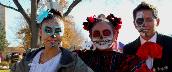 Three Day of the Dead dancers wearing face paint