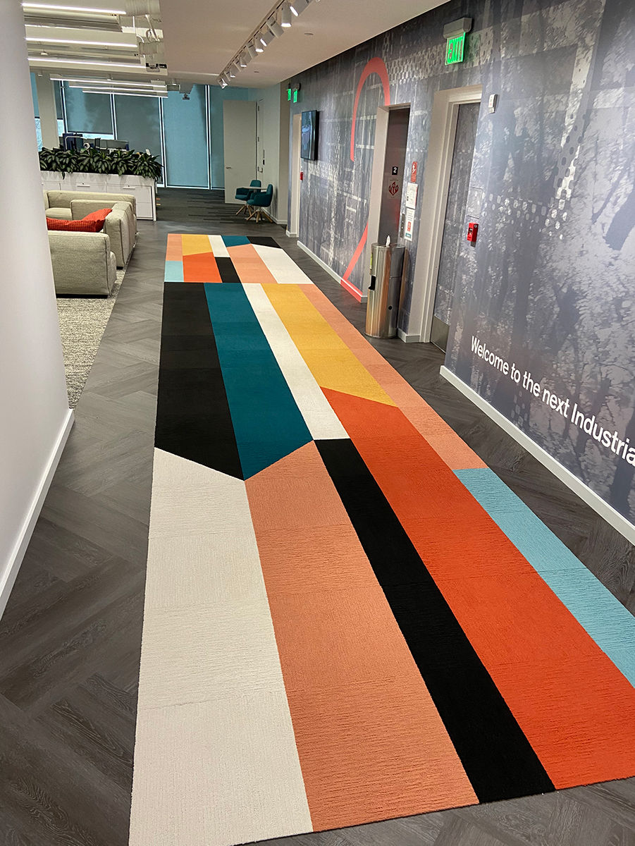 Base Camp's carpet, an Interface product, offers both directional signage and style. Photo credit: Interface