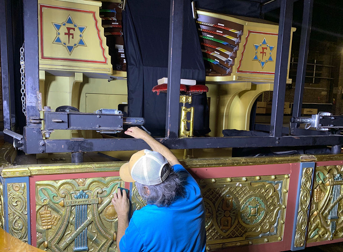A tech cleans the organ skirt on Mighty Mo.