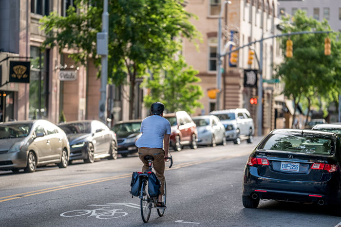 Man biking in the street in Downtown Raleigh