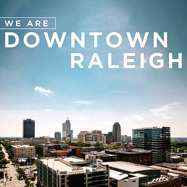 We Are Downtown Raleigh logo over skyline of Downtown Raleigh