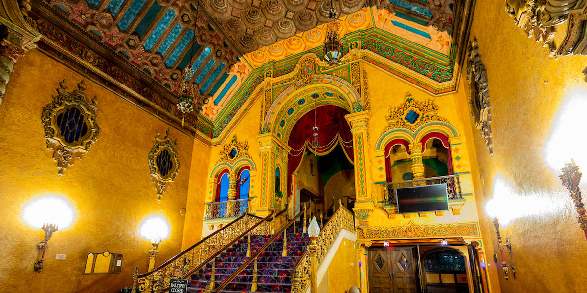 An image of the main staircase at the ornately decorated Akron Civic Theatre.